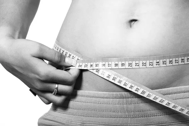 Image of a woman measuring waist circumference