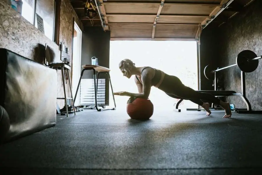 Image of a woman working out in a shed.