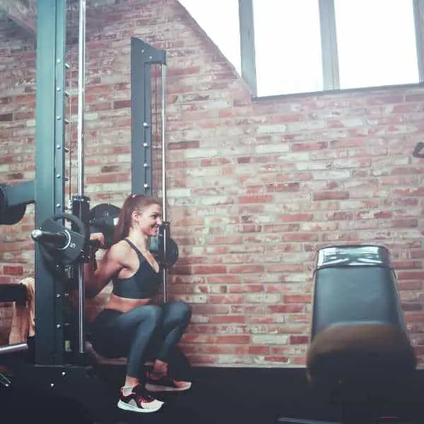 Image of a woman squatting in a smith machine