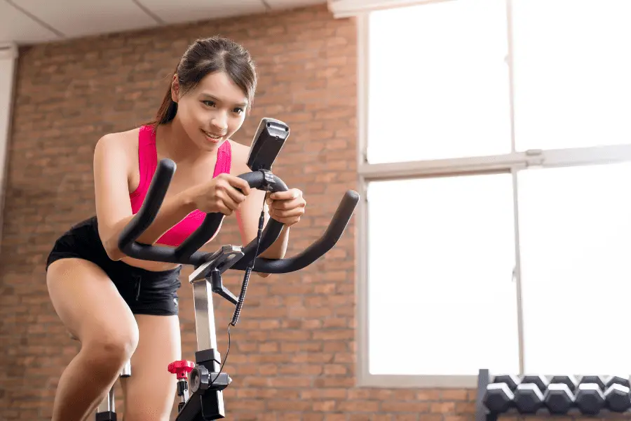 Image of a woman working out on an exercise bike.