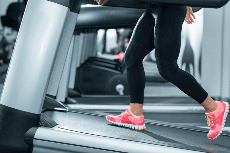 Image of a woman walking on an inclined treadmill. 