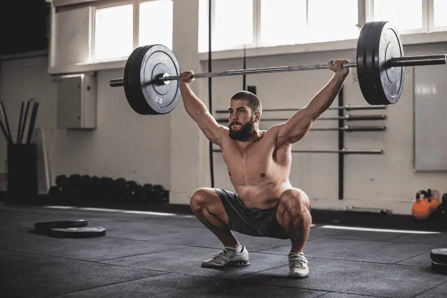 Image of a man holding a barbell overhead.