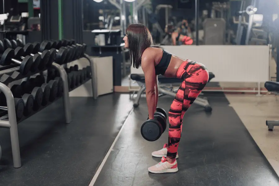 Image of a woman doing dumbbell good mornings.