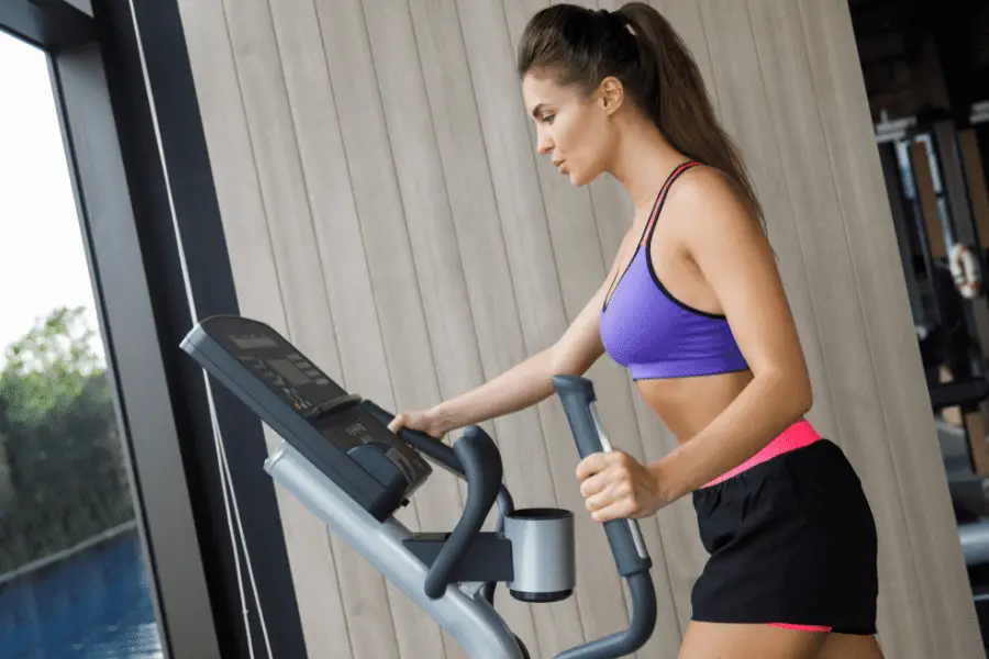 Image of a woman using an elliptical trainer.