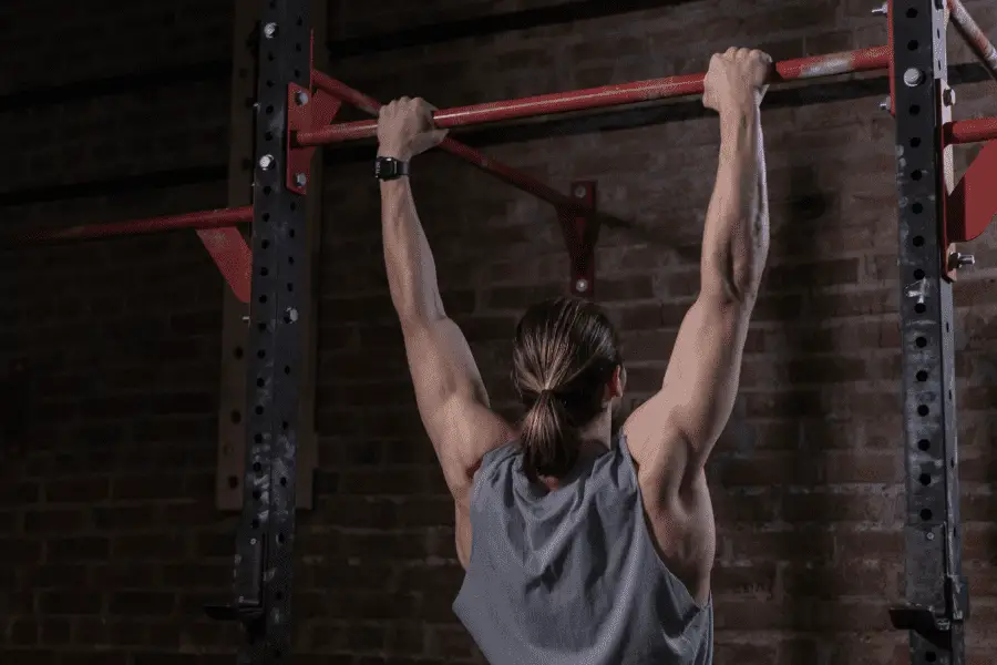 Image of a man hanging from a pull up bar