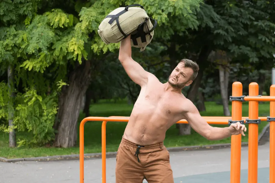 Image of a man lifting a backpack as exercise