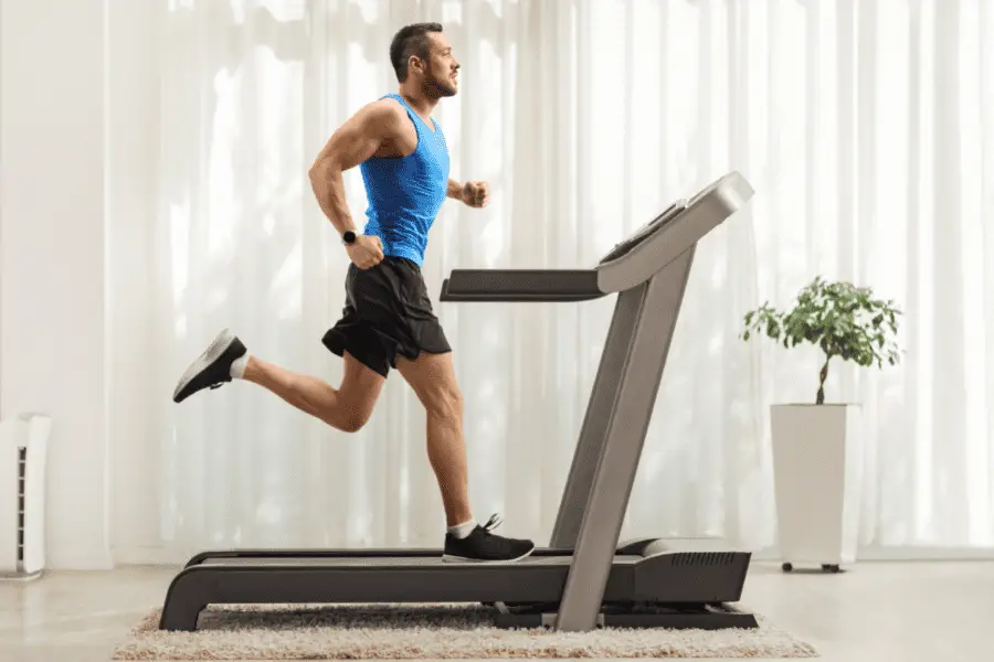 Image of a treadmill with man running on it. 