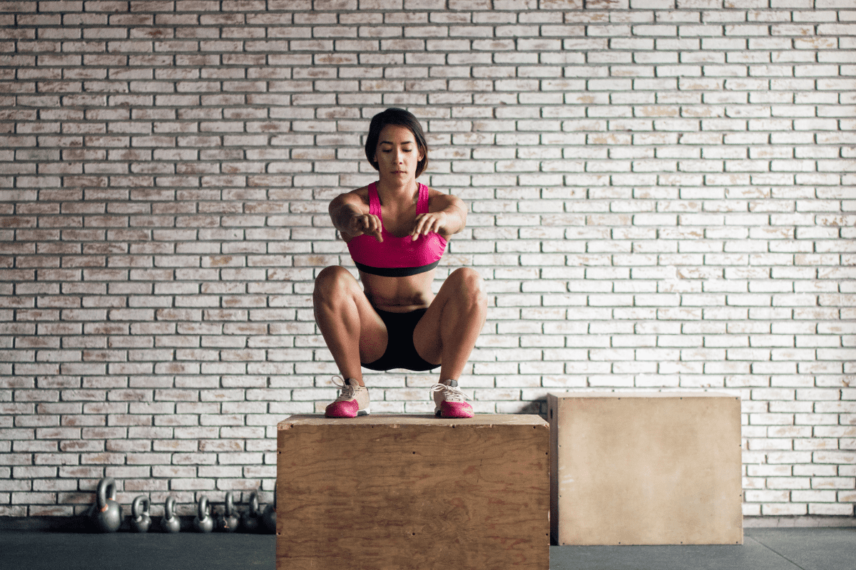 Image of a woman jumping on a plyo box
