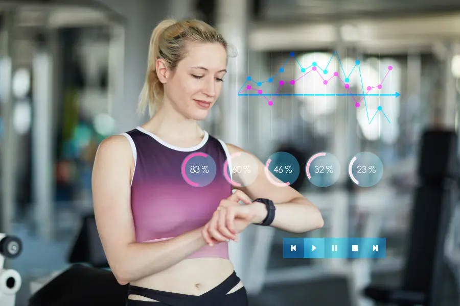 Woman looking at fitness statistics in front of smart mirror